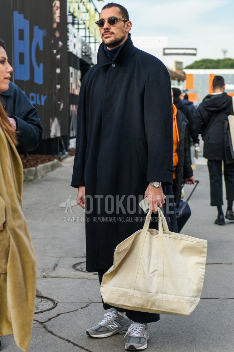 Men's fall/winter outfit with plain black sunglasses, plain black stainless steel collar coat, plain gray turtleneck knit, New Balance m990v5 gray low-cut sneakers, and plain beige tote bag.
