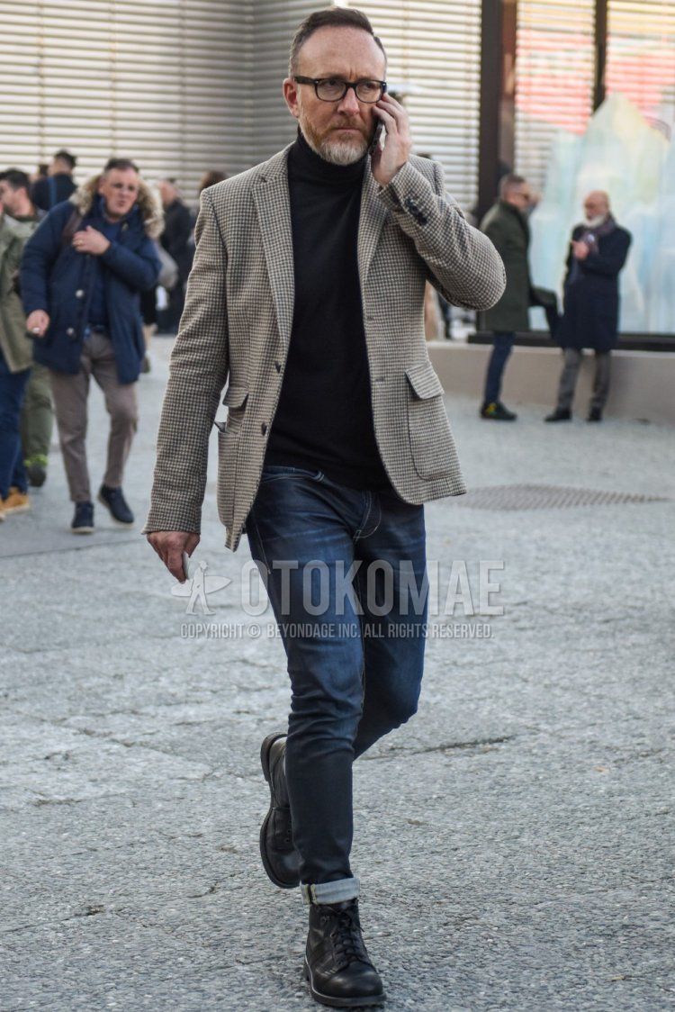 Men's spring/autumn coordinate/outfit with plain black glasses, gray checked tailored jacket, plain black turtleneck knit, plain navy denim/jeans, and black boots.