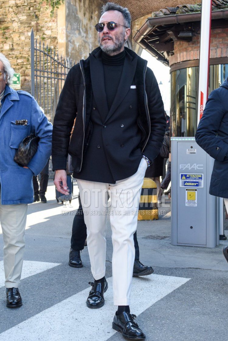 Men's fall/winter coordinate and outfit with plain black sunglasses, plain black leather jacket (other than rider's), plain black tailored jacket, plain black turtleneck knit, plain white ankle pants, plain white slacks, plain black socks, and black monk shoes leather shoes.