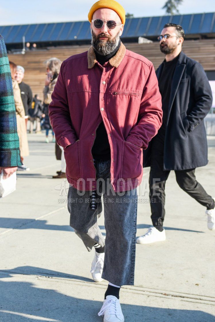 Men's fall/winter outfit with solid yellow knit cap, clear solid sunglasses, solid red coveralls, solid black turtleneck knit, solid gray denim/jeans, solid gray cropped pants, solid black socks, and white low-cut sneakers.