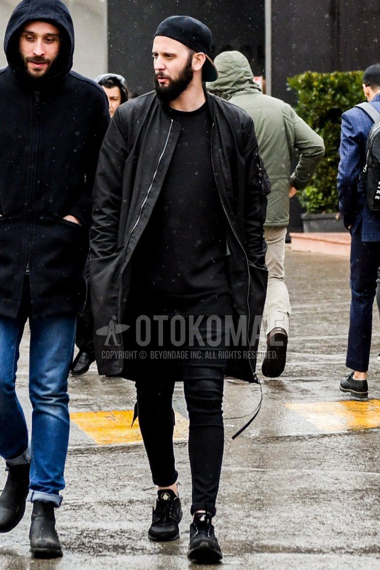 Winter men's coordinate and outfit with plain black baseball cap, plain black MA-1, plain black sweater, plain black skinny pants, and black low-cut sneakers.