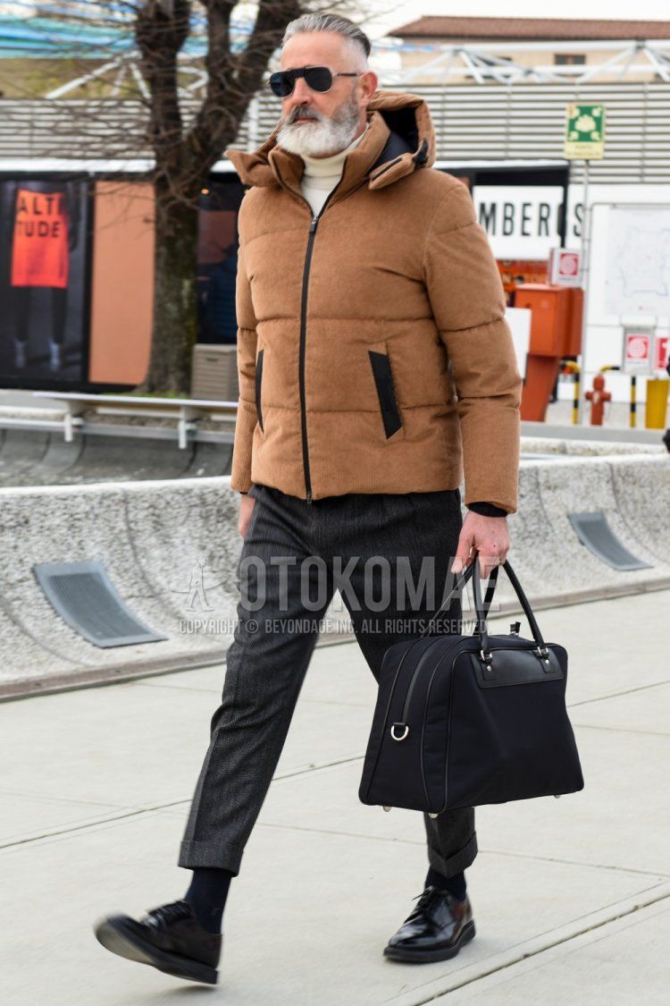 Teardrop solid black sunglasses, solid brown down jacket, solid white turtleneck knit, gray striped slacks, gray striped cropped pants, solid black socks, black straight tip leather shoes, solid black briefcase/handbag for fall/winter Men's Codes and Outfits.