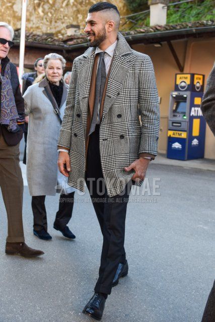 Men's fall/winter outfit and outfit with gray checked chester coat, solid beige tailored jacket, white striped shirt, solid gray slacks, solid gray ankle pants, solid black socks, black plain toe leather shoes, and solid gray tie.