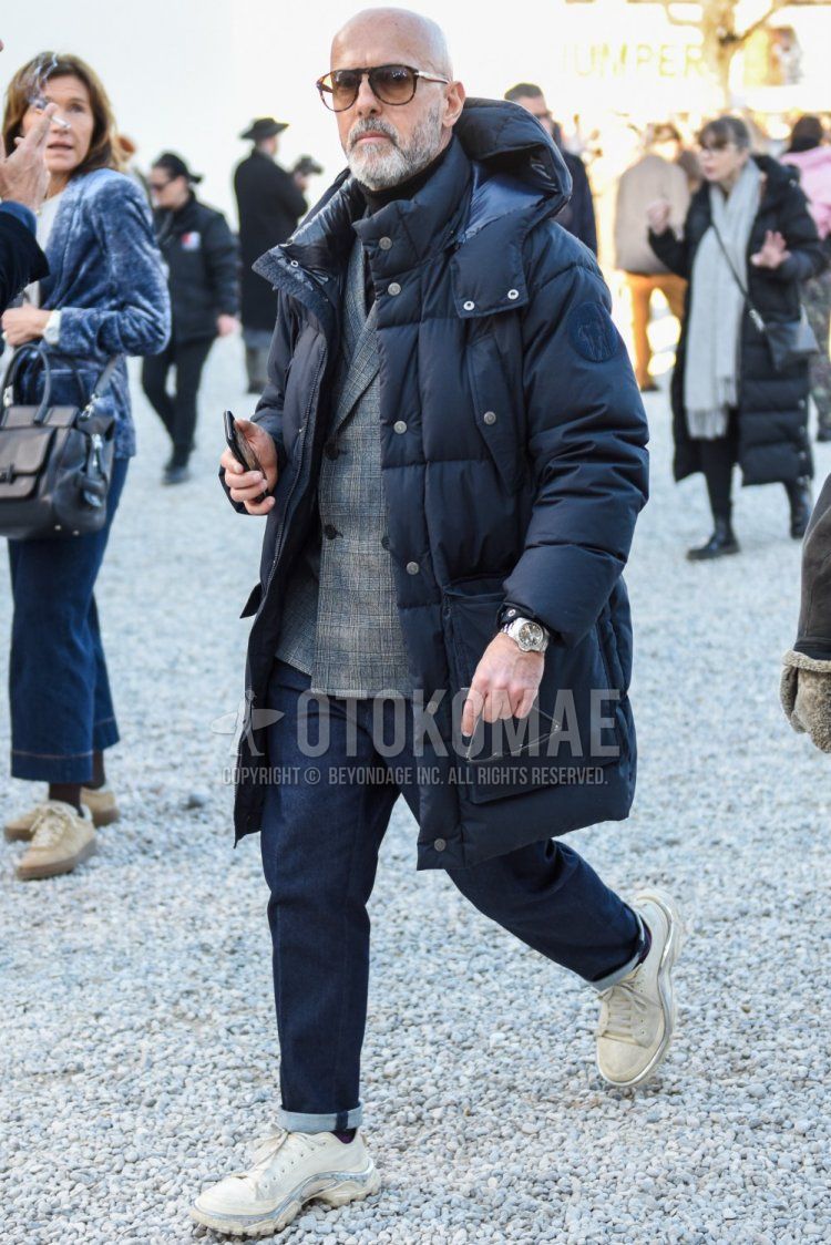Brown tortoiseshell sunglasses, solid black down jacket, solid black hooded coat, gray checked tailored jacket, solid black turtleneck knit, solid navy denim/jeans, solid red socks, Raf Simons Adidas Detroit Runner white low cut Men's winter coordinate/outfit with sneakers.