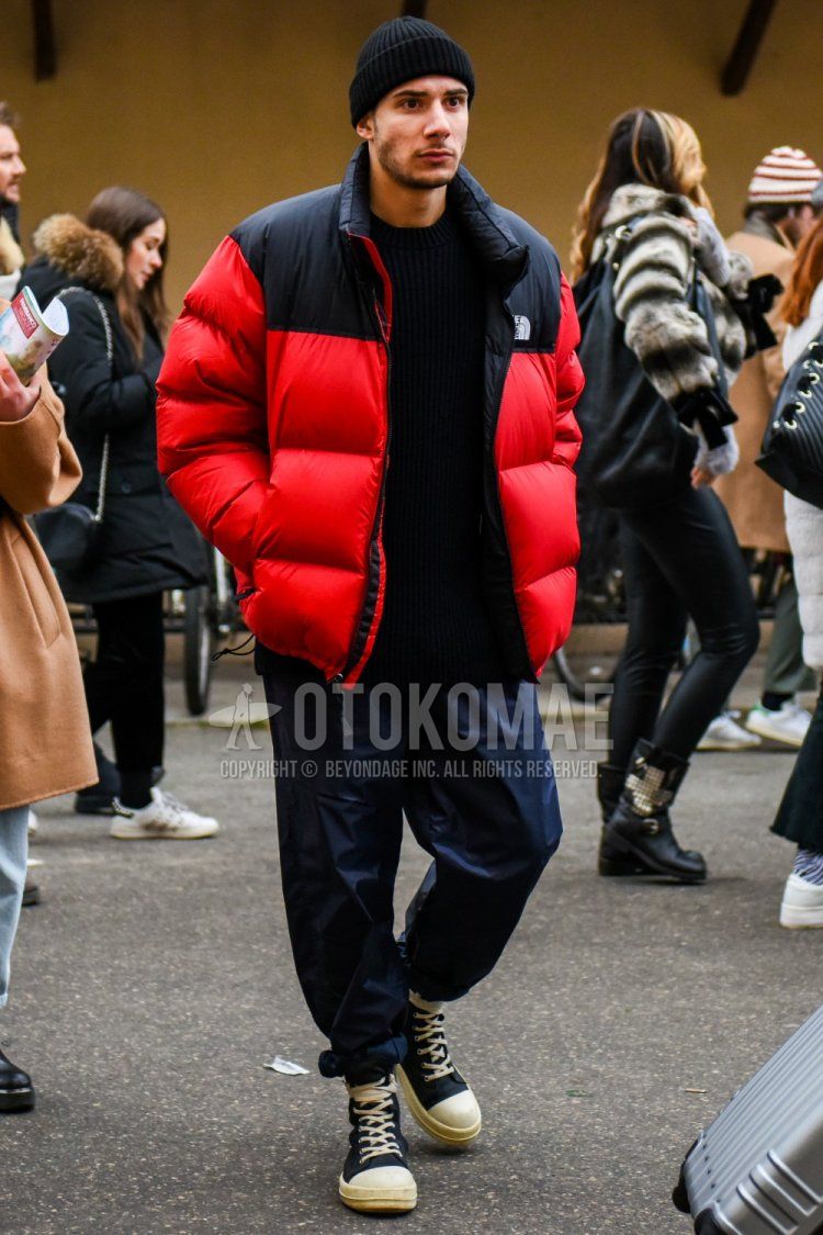Winter men's coordinate and outfit with plain black knit cap, The North Face red plain down jacket, plain black sweater, plain navy wide pants, and black high-cut sneakers.