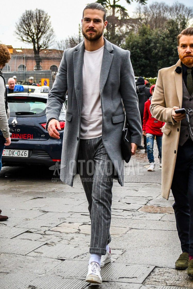 Men's fall/winter outfit/coat with plain gray chester coat, plain white t-shirt, gray striped slacks, gray striped easy pants, plain white socks, white low-cut sneakers, and plain black clutch/second bag/drawstring bag.