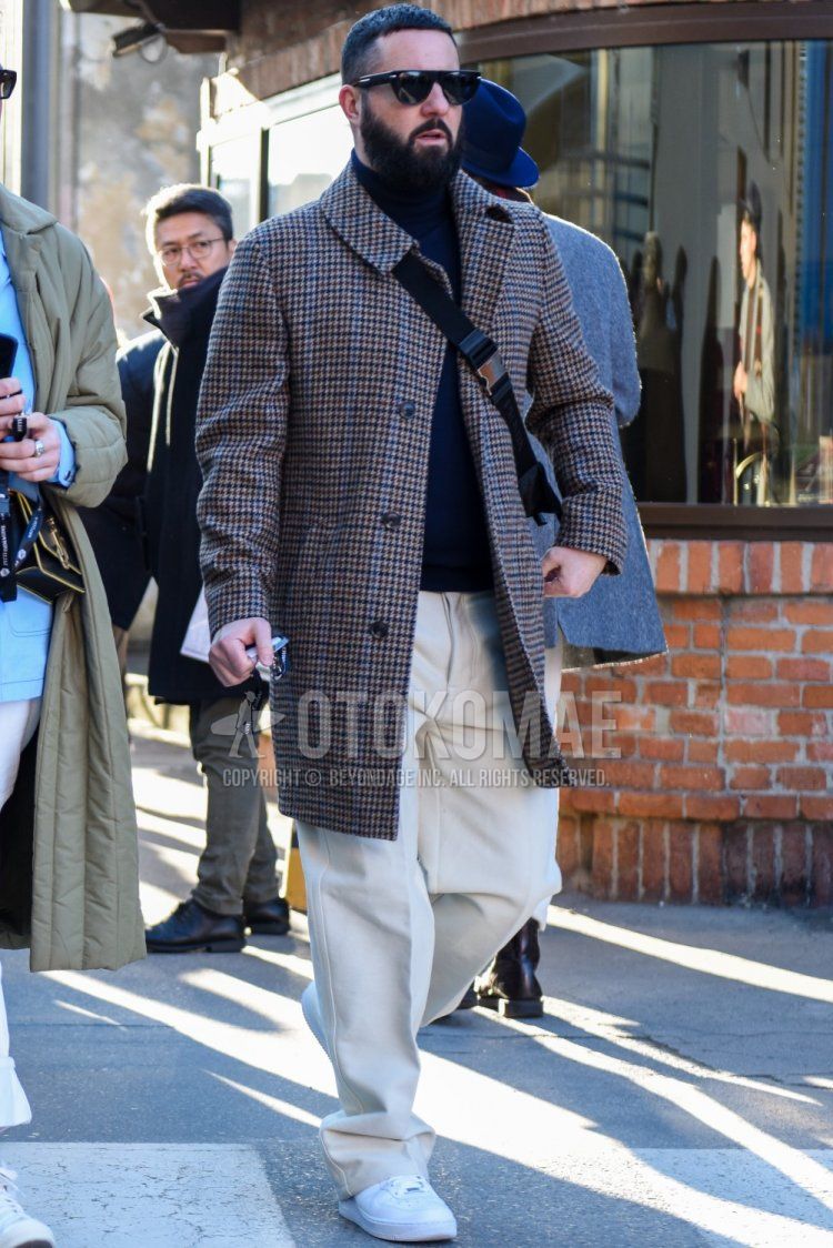 Men's fall/winter coordinate and outfit with plain black sunglasses, gray checked stainless steel coat, plain navy turtleneck knit, plain beige chinos, and white low-cut sneakers.