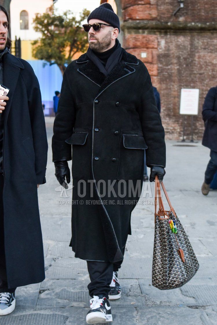 Solid black knit cap, solid black sunglasses, solid dark gray scarf/stall, solid black outerwear, solid black turtleneck knit, solid gray slacks, Nike Peace Minus One Air Force 1 black low cut sneakers, Goyard gray bag briefcase/ Men's fall/winter outfits and outfits with handbags.