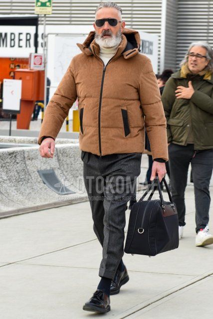 Winter men's outfit/clothing with solid black sunglasses, solid beige down jacket, solid white turtleneck knit, solid gray slacks, solid gray cropped pants, solid black socks, solid black plain toe leather shoes, and solid black briefcase/handbag.