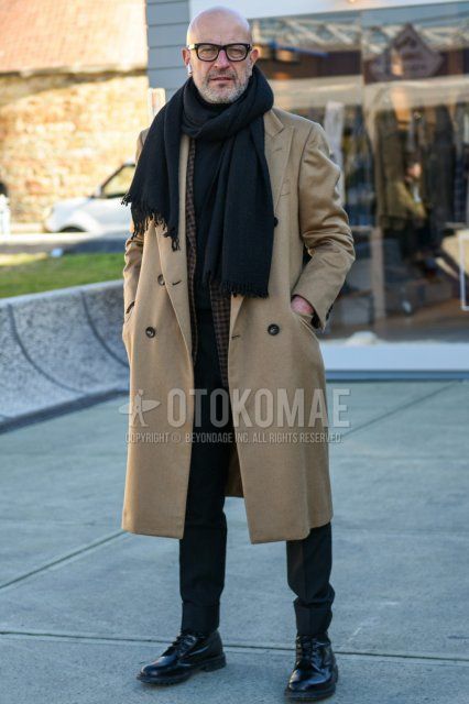 Men's fall/winter outfit with plain black glasses, plain dark gray scarf/stall, plain beige chester coat, brown checked tailored jacket, plain gray slacks, plain gray cropped pants, and black boots.