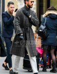 Men's fall/winter outfit with teardrop plain black sunglasses, gray checked belted coat, plain white slacks, plain black socks, and Gucci black bit loafer leather shoes.
