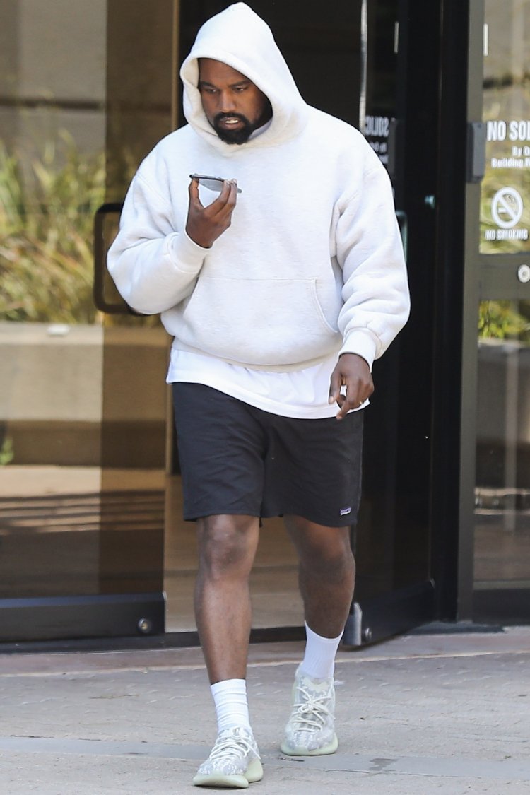 *EXCLUSIVE* Kanye West steps out of Los Angeles office meeting and covers up in a white hoodie
