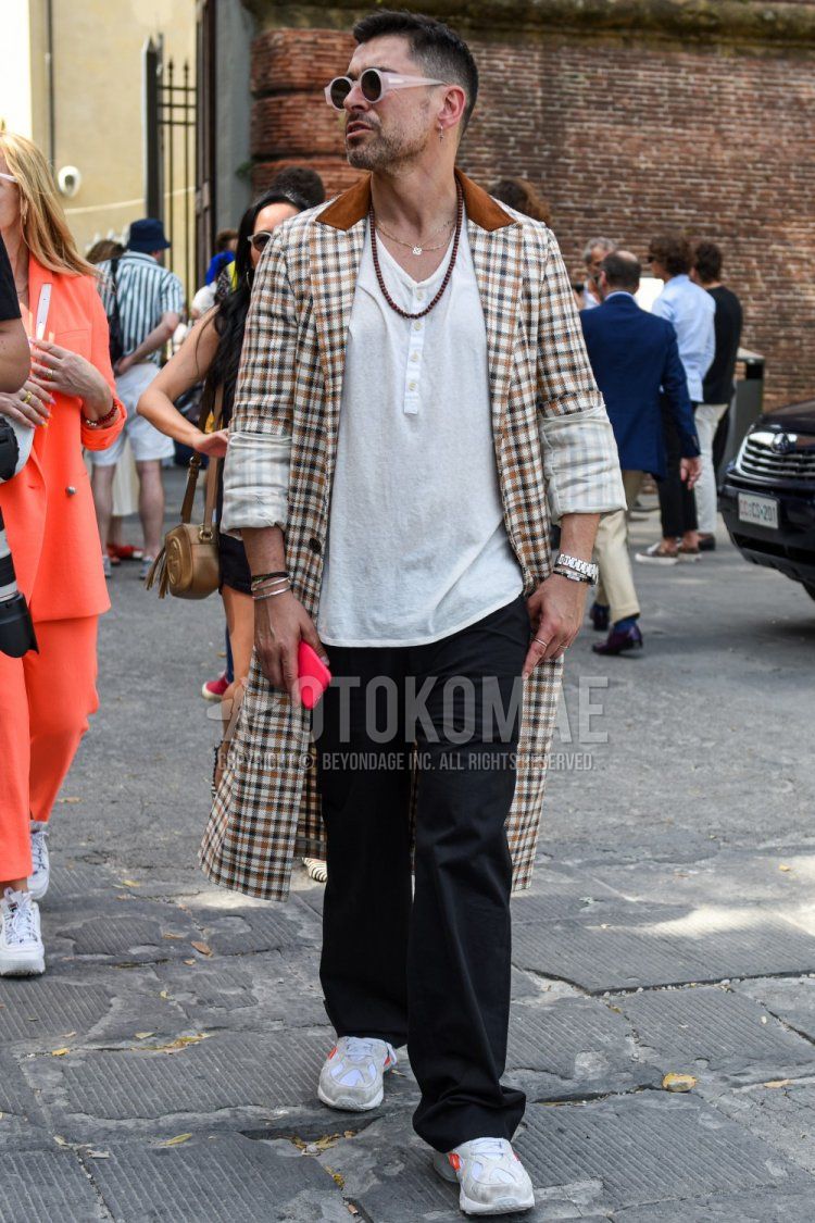 Men's spring, summer, and fall coordinate and outfit with clear plain sunglasses, beige check chester coat, plain white t-shirt with henley neck, plain black wide pants, and white low-cut sneakers by Lotto.