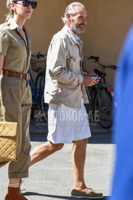 Spring men's coordinate and outfit with plain beige outerwear, light blue striped shirt, plain white shorts, plain cotton pants, and beige moccasins/deck shoes leather shoes.