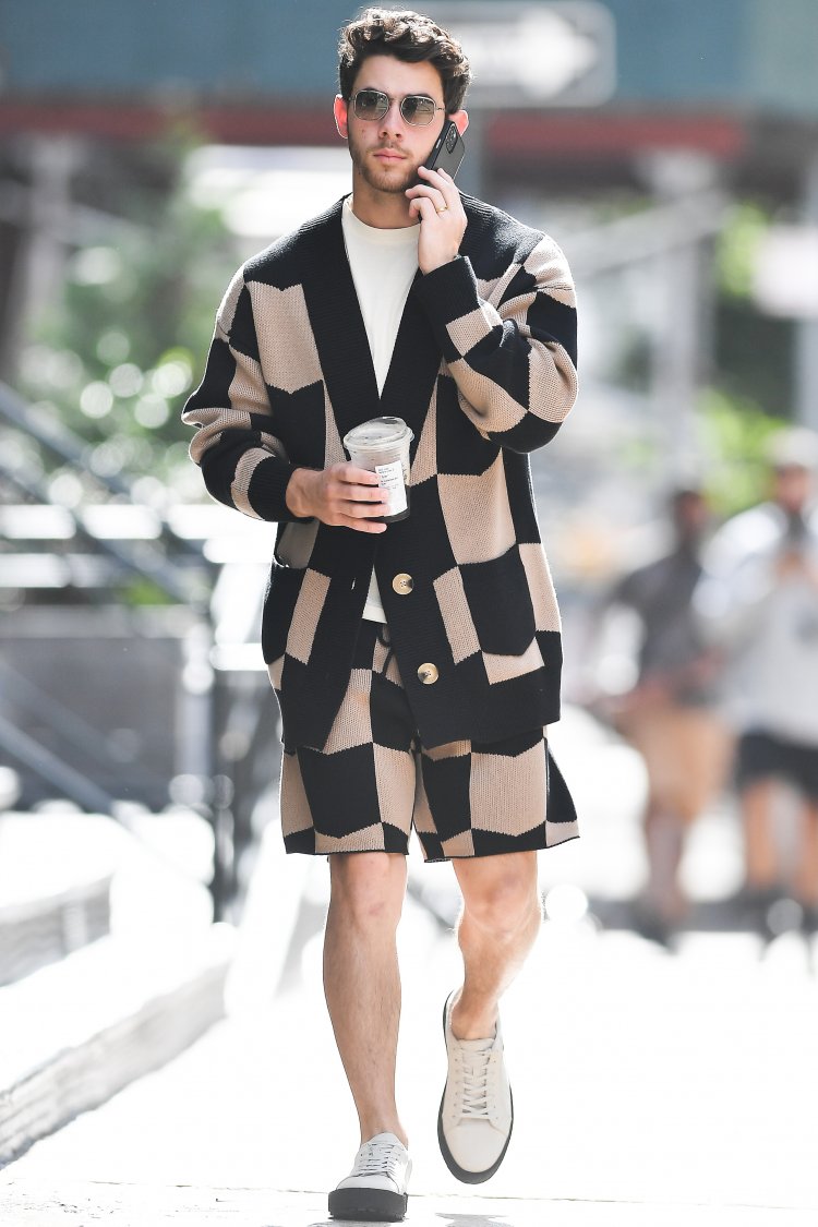 Nick Jonas wears a patterned outfit while grabbing a coffee in New York City