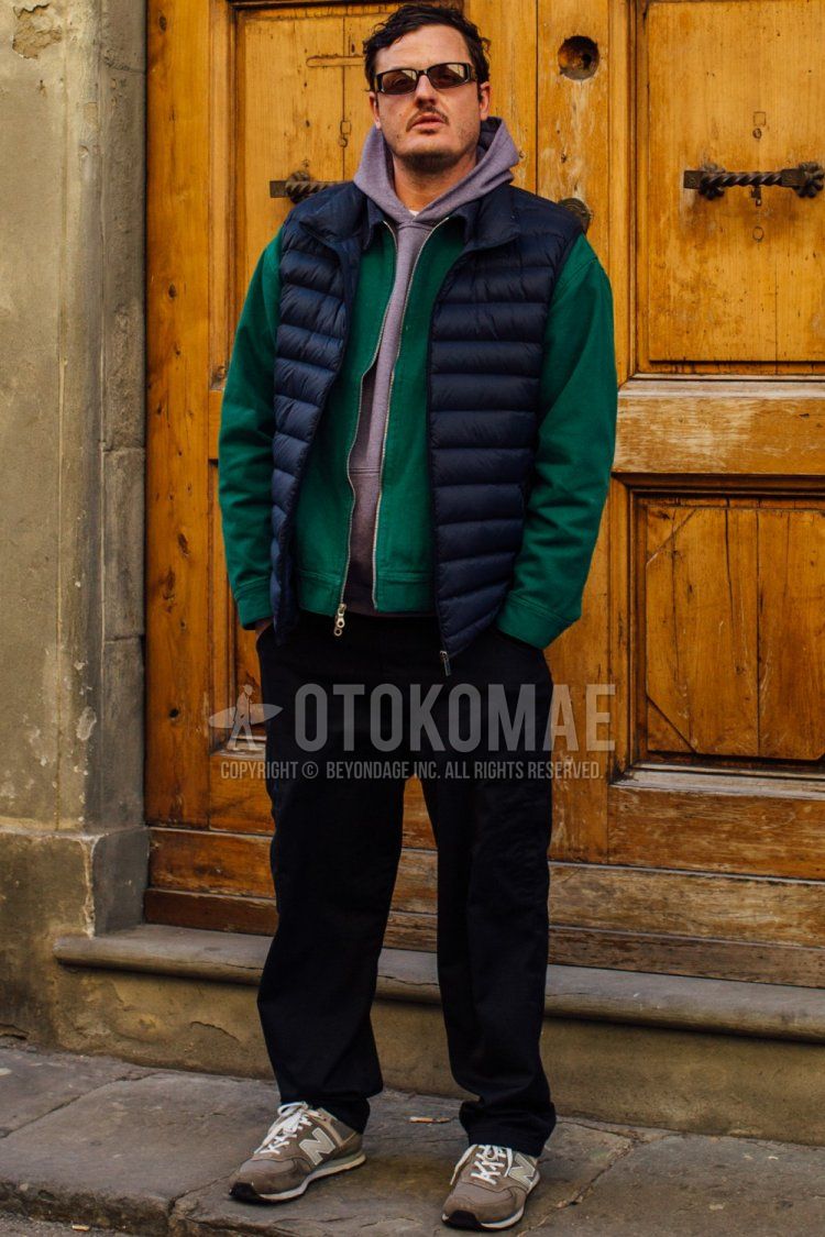 Winter/spring men's coordinate and outfit with solid black sunglasses, solid black down jacket, solid green swing top, solid purple hoodie, solid black cotton pants, solid black wide-leg pants, and gray low-cut sneakers.