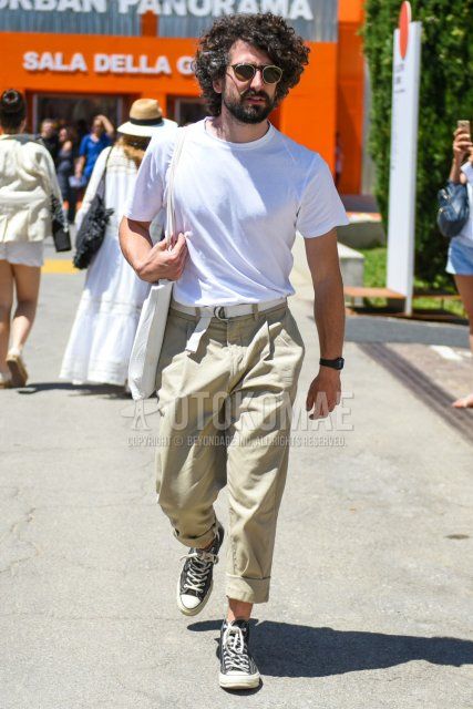 Men's summer coordinate and outfit with plain black sunglasses, plain white T-shirt, plain white tape belt, plain beige cotton pants, and black high-cut Converse sneakers.