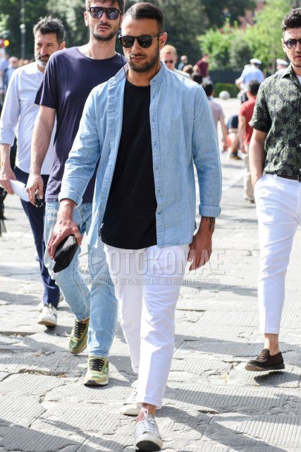 Men's spring/summer coordinate and outfit with plain black Tom Ford sunglasses, plain light blue shirt with band collar, plain black t-shirt, plain white cotton pants, and white low-cut sneakers.
