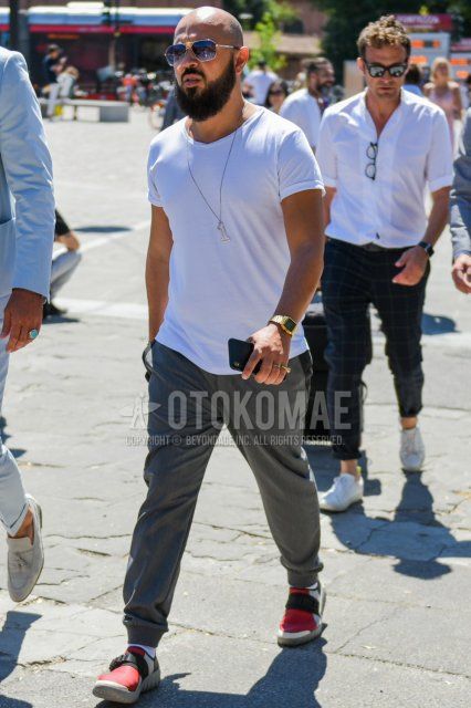 Summer men's coordinate and outfit with plain silver sunglasses, plain white t-shirt, plain gray jogger pants/ribbed pants, plain white socks, and red low-cut sneakers.