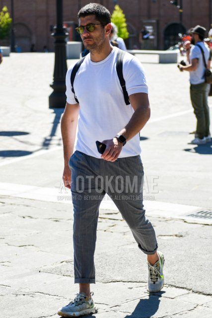 Men's spring and summer coordinate and outfit with plain black sunglasses, plain white t-shirt, gray striped slacks, and Nike React Element 55 gray low-cut sneakers.