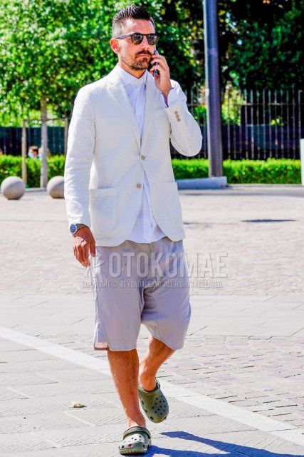 Summer/spring men's coordinate and outfit with plain black sunglasses, plain white tailored jacket, plain white shirt, plain gray shorts, and olive green sandals.
