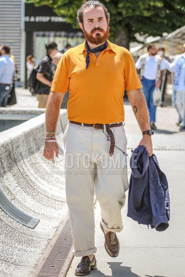 Men's spring/summer coordinate and outfit with blue/navy striped bandana/neckerchief, plain yellow polo shirt, plain brown mesh belt, plain beige/white wide-leg pants, and brown coin loafer leather shoes.