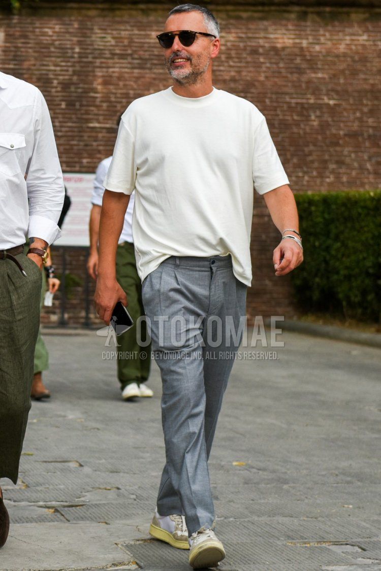 Men's spring/summer coordinate and outfit with brown tortoiseshell sunglasses, plain white t-shirt, plain gray slacks, and white low-cut sneakers.
