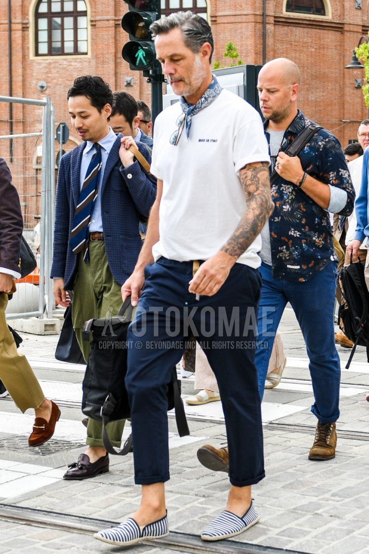Men's summer coordinate and outfit with blue stole scarf, white one-pointed T-shirt, plain navy cropped pants, plain chinos and navy/white striped espadrilles.