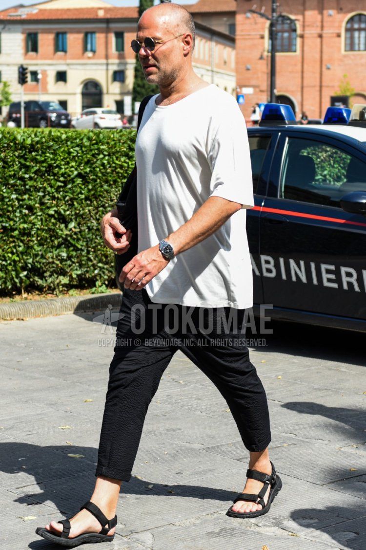 Men's summer coordinate and outfit with plain silver sunglasses, plain white T-shirt, and black sports sandals.