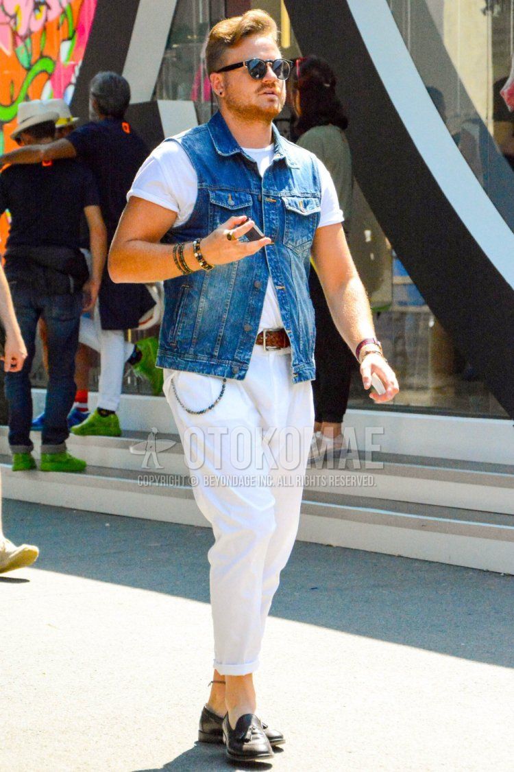 Summer men's coordinate and outfit with solid color sunglasses, solid color blue gilet, solid color white shirt, solid color brown leather belt, solid color white cotton pants, and brown tassel loafer leather shoes.