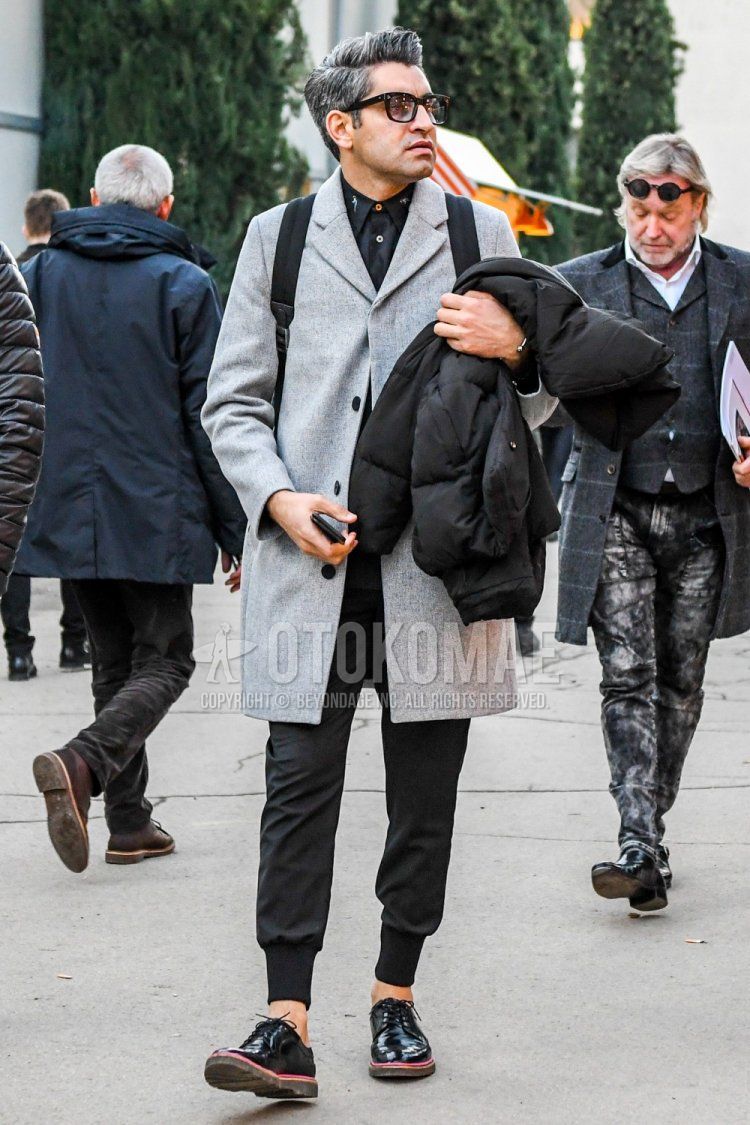 Winter men's coordinate and outfit with plain sunglasses, plain gray chester coat, plain black shirt, plain black jogger pants/ribbed pants, and black plain toe leather shoes.