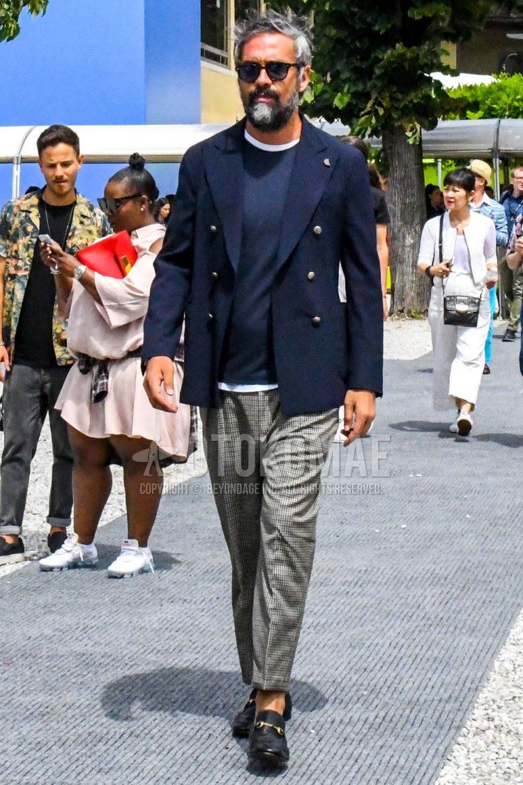 Men's spring, summer, and fall coordinate and outfit with plain sunglasses, plain navy tailored jacket, plain black t-shirt, plain white t-shirt, gray checked ankle pants, and black bit loafer leather shoes.