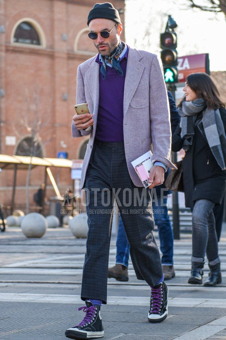 Solid black knit cap, solid gold sunglasses, gray stole bandana/neckerchief, solid purple tailored jacket, solid purple sweater, solid light blue shirt, gray checked slacks, gray checked cropped pants, solid gray socks, Converse All Star black high-cut sneakers for men in spring and fall.