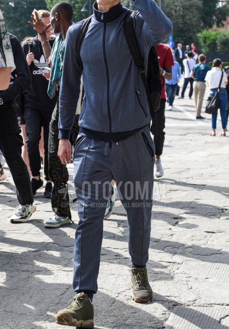 Men's spring, summer, and fall coordinate and outfit with plain navy baseball cap, plain gray outerwear, plain gray jogger pants/ribbed pants, and olive green high-cut sneakers.