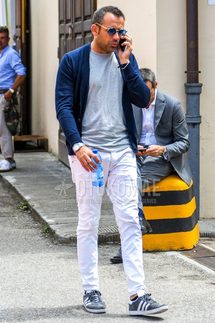 Men's spring, summer, and fall coordinate and outfit with plain sunglasses, plain navy cardigan, plain gray t-shirt, plain white damaged jeans, and Adidas gray low-cut sneakers.