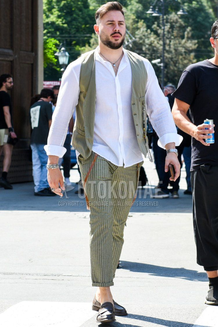 Men's spring/fall/summer men's coordinate and outfit with plain gray casual vest, band collar plain white shirt, gray striped slacks, gray striped cropped pants, and brown coin loafer leather shoes.