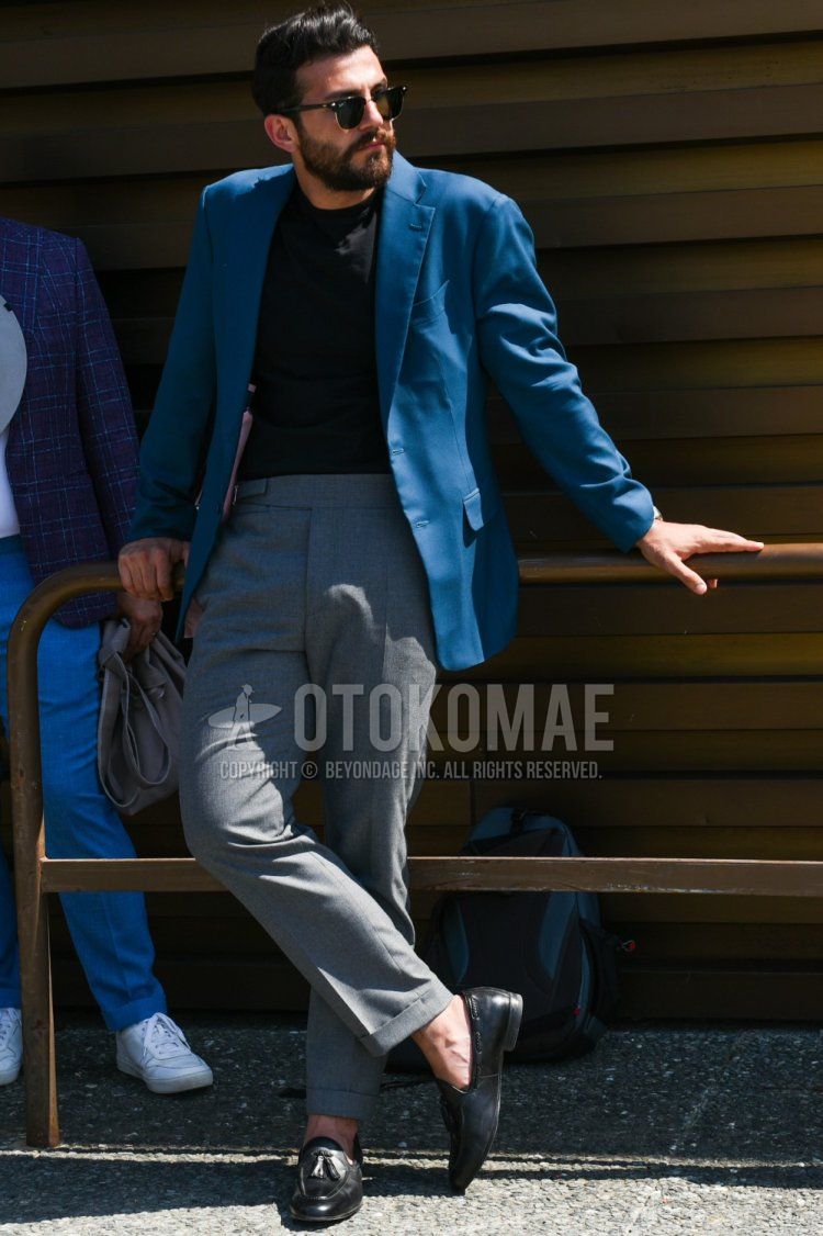 Summer/spring men's coordinate and outfit with plain black sunglasses, plain blue tailored jacket, plain black t-shirt, plain gray beltless pants, and black tassel loafer leather shoes.