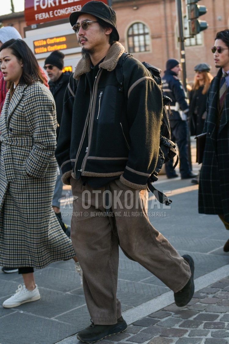 Men's fall/winter coordinate and outfit with plain brown hat, brown tortoiseshell sunglasses, plain black fleece jacket, solid beige winter pants (corduroy, velour), and dark gray low-cut sneakers.