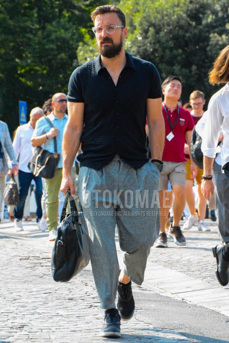 Men's summer coordinate and outfit with solid color glasses, solid color black shirt, solid color gray pleated pants, solid color gray wide pants, black high cut sneakers, solid color black briefcase/handbag.