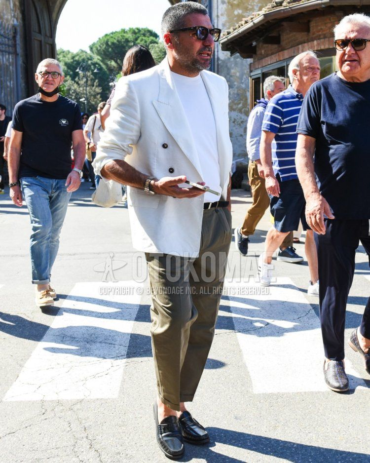 Summer/spring men's coordinate and outfit with plain black sunglasses, plain white tailored jacket, plain white t-shirt, plain black leather belt, plain olive green slacks, and black coin loafer leather shoes.