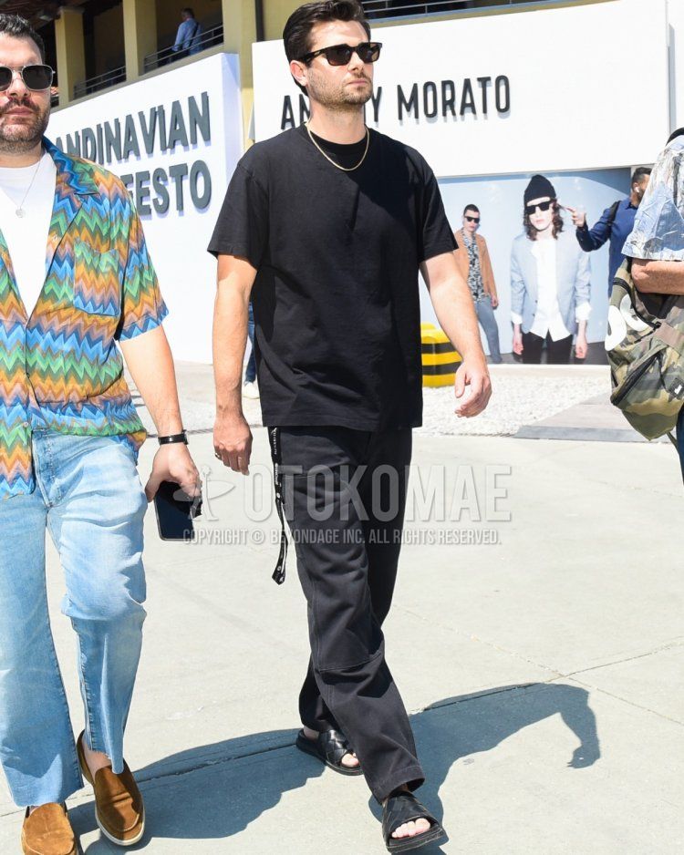 Men's spring and summer coordinate and outfit with plain black sunglasses, plain black t-shirt, plain black baker pants, and black leather sandals.