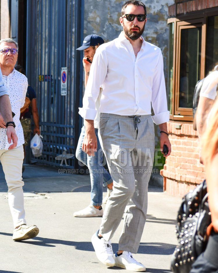 Men's spring and summer coordinate and outfit with plain black sunglasses, plain white shirt, gray checked easy pants, and white low-cut sneakers.