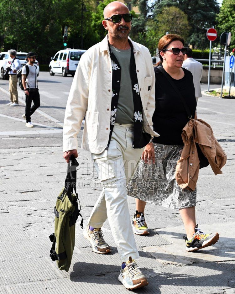 Men's summer/autumn/spring coordinate and outfit with plain black sunglasses, plain white coveralls, all-over black shirt, plain gray t-shirt, plain white cargo pants, and white low-cut sneakers.