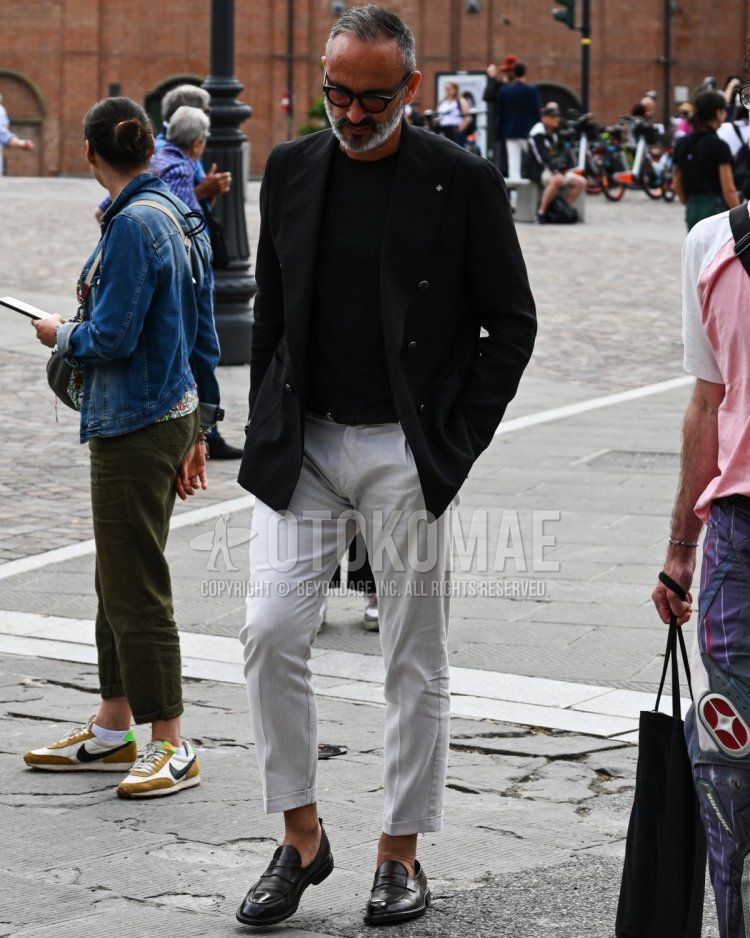 Men's spring, summer, and fall coordinate and outfit with plain brown sunglasses, plain black tailored jacket, plain black T-shirt, plain white slacks, and black coin loafer leather shoes.