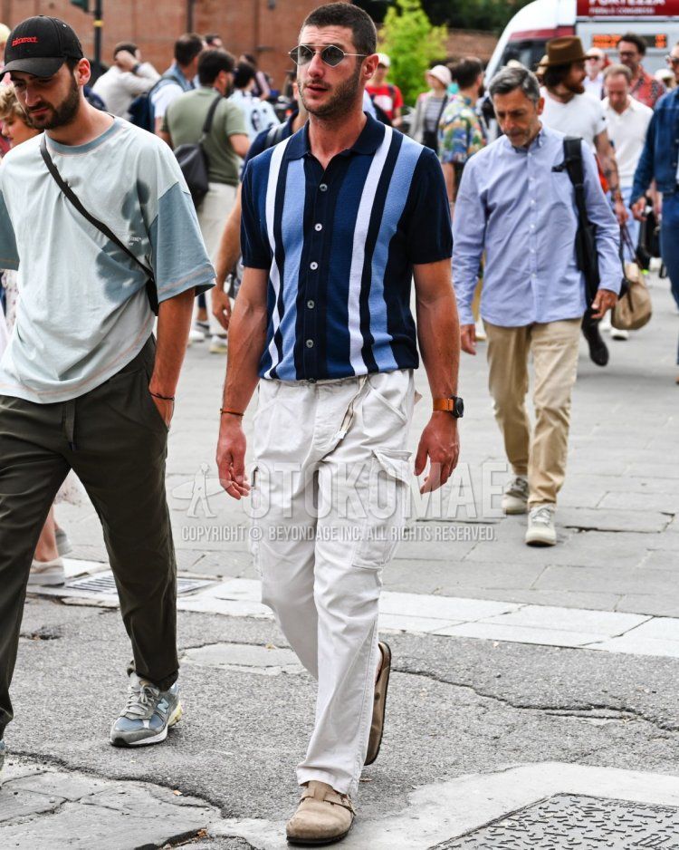 Summer/spring men's coordinate and outfit with plain blue sunglasses, blue striped polo shirt, plain white cargo pants, and Birkenstock beige leather sandals.