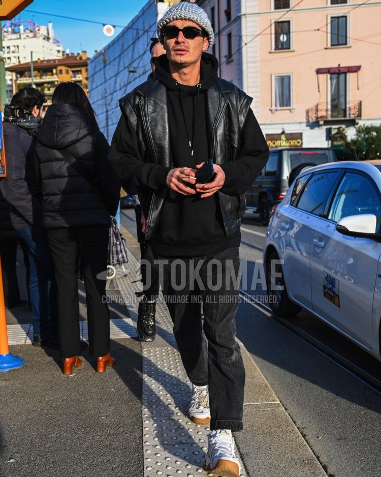 Men's fall/winter coordinate and outfit with plain gray knit cap, plain black sunglasses, plain black leather jacket (not riders), plain black hoodie, plain black denim/jeans, and white high-cut sneakers.