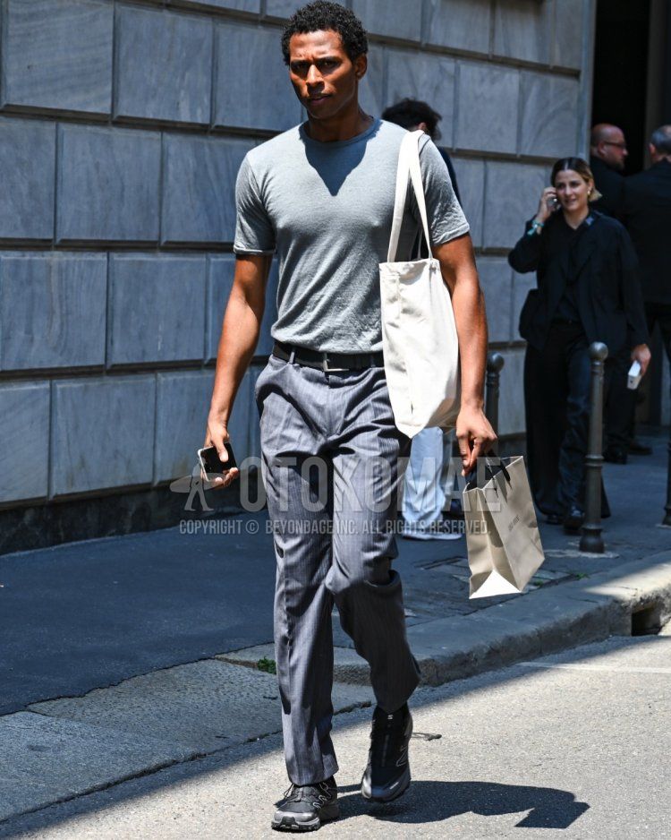 Men's spring and summer coordinate and outfit with plain gray T-shirt, plain black leather belt, gray striped slacks, black low-cut sneakers, and plain white tote bag.