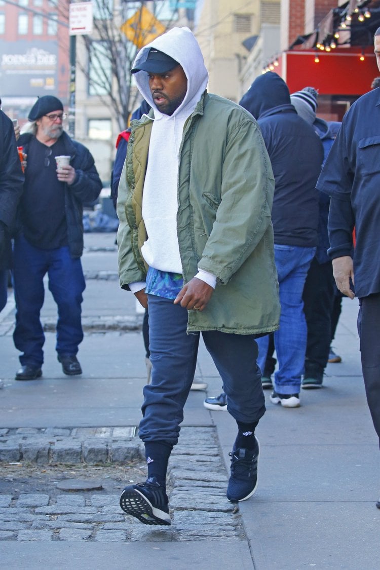 EXCLUSIVE: Kanye West signs autographs wearing a military jacket and Yeezy Adidas shoes in New York City