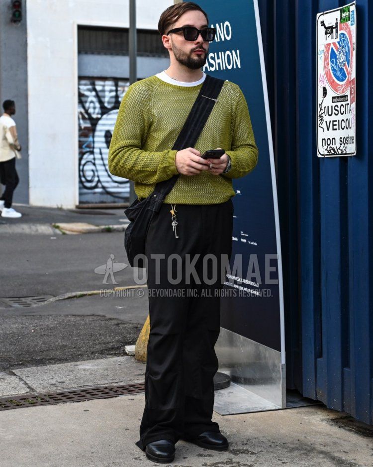 Men's spring, summer, and fall coordinate and outfit with plain black sunglasses, plain white t-shirt, plain green sweater, plain black wide-leg pants, black coin loafer leather shoes, and plain black shoulder bag.
