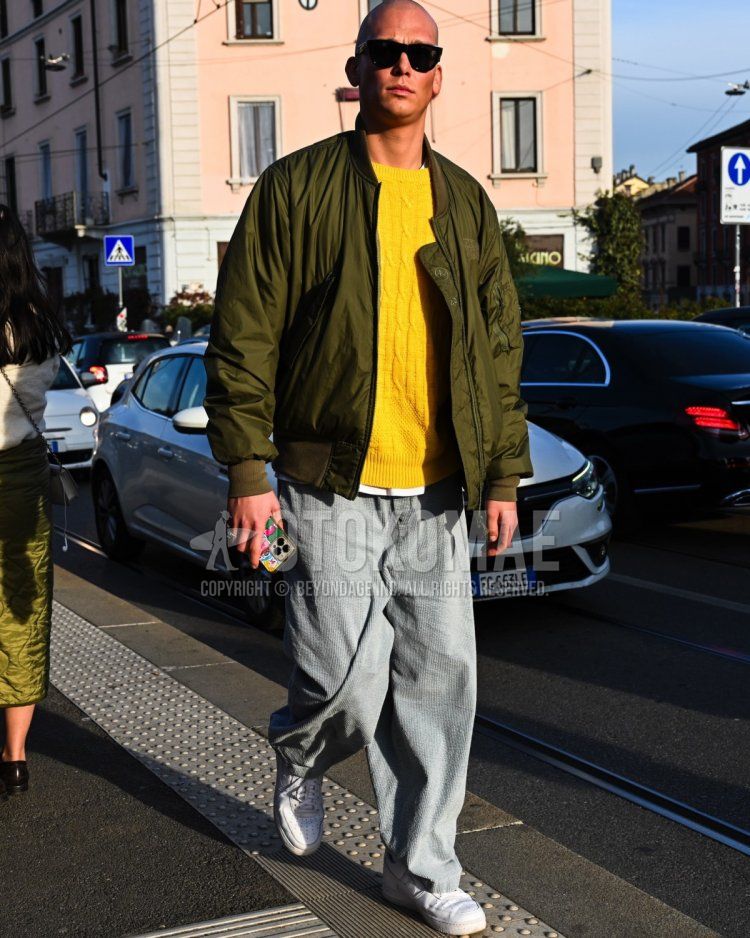 Men's fall/winter coordinate and outfit with plain black sunglasses, plain olive green MA-1, plain yellow sweater, gray striped slacks, and Nike Air Force 1 white low-cut sneakers.